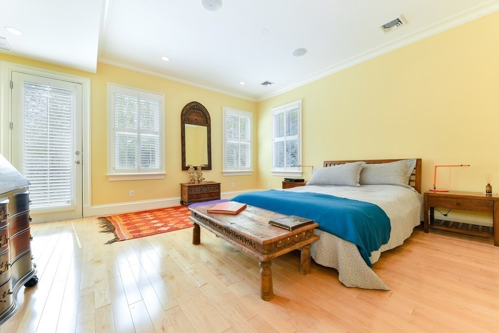 265 Upland Road Cambridge, MA 02140 - Photo 18 of 39 a bedroom with a bed and wooden floor