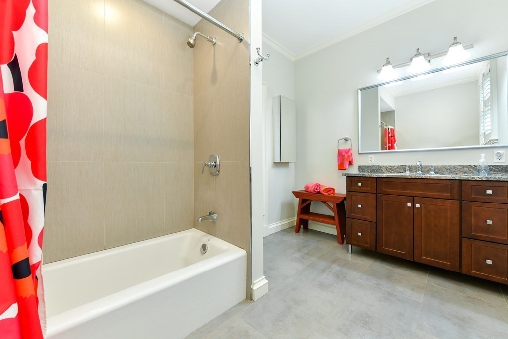 265 Upland Road Cambridge, MA 02140 - Photo 25 of 39 a bathroom with a tub a sink and a mirror