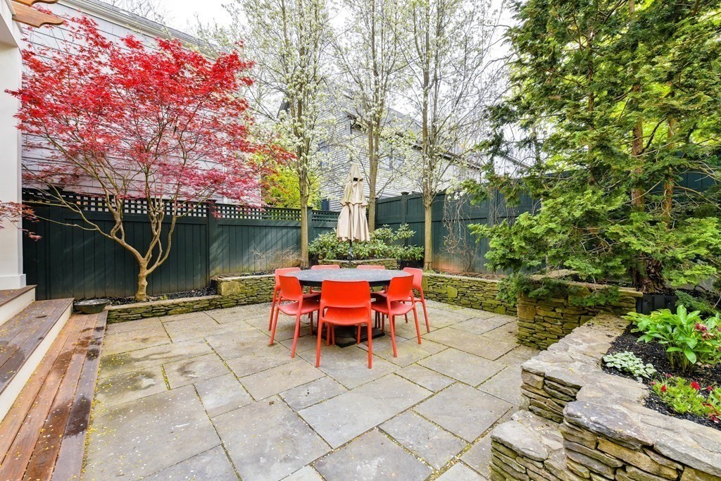 265 Upland Road Cambridge, MA 02140 - Photo 37 of 39 a backyard of a house with yard table and chairs