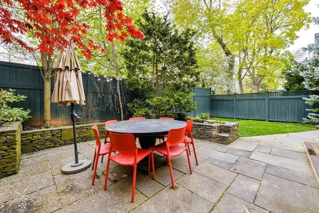 265 Upland Road Cambridge, MA 02140 - Photo 38 of 39 a backyard of a house with table and chairs