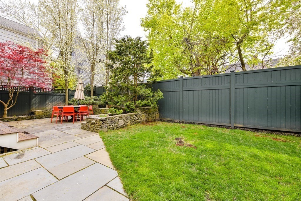 265 Upland Road Cambridge, MA 02140 - Photo 39 of 39 a view of a backyard with a car park and trees