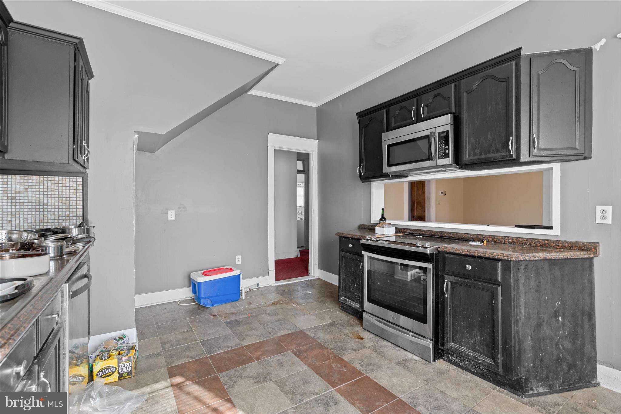 26740 Old State Road Crisfield, MD 21817 - Photo 16 of 49 a kitchen with stainless steel appliances granite countertop a stove a sink and a microwave
