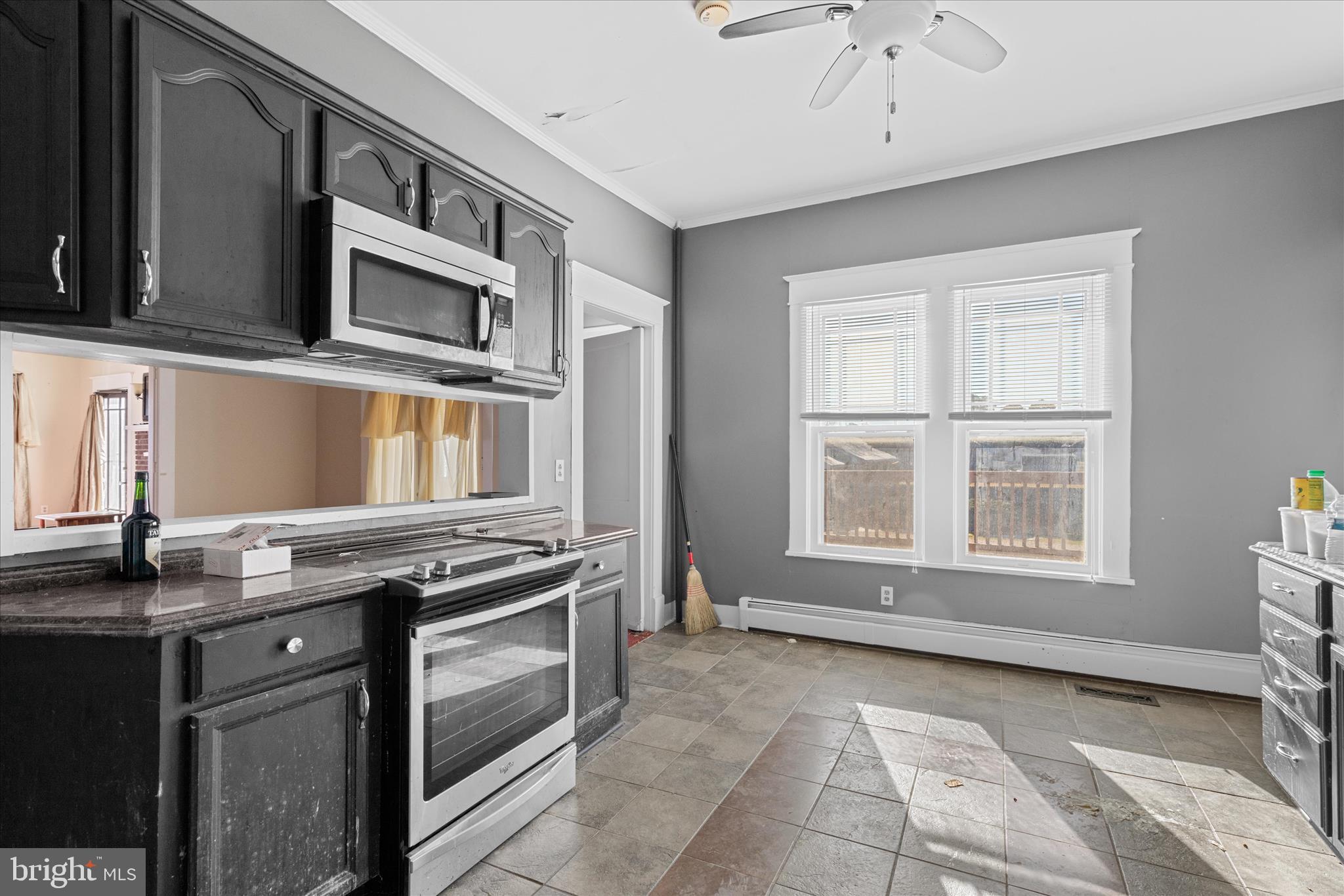 26740 Old State Road Crisfield, MD 21817 - Photo 18 of 49 a kitchen with stainless steel appliances granite countertop a stove and a microwave