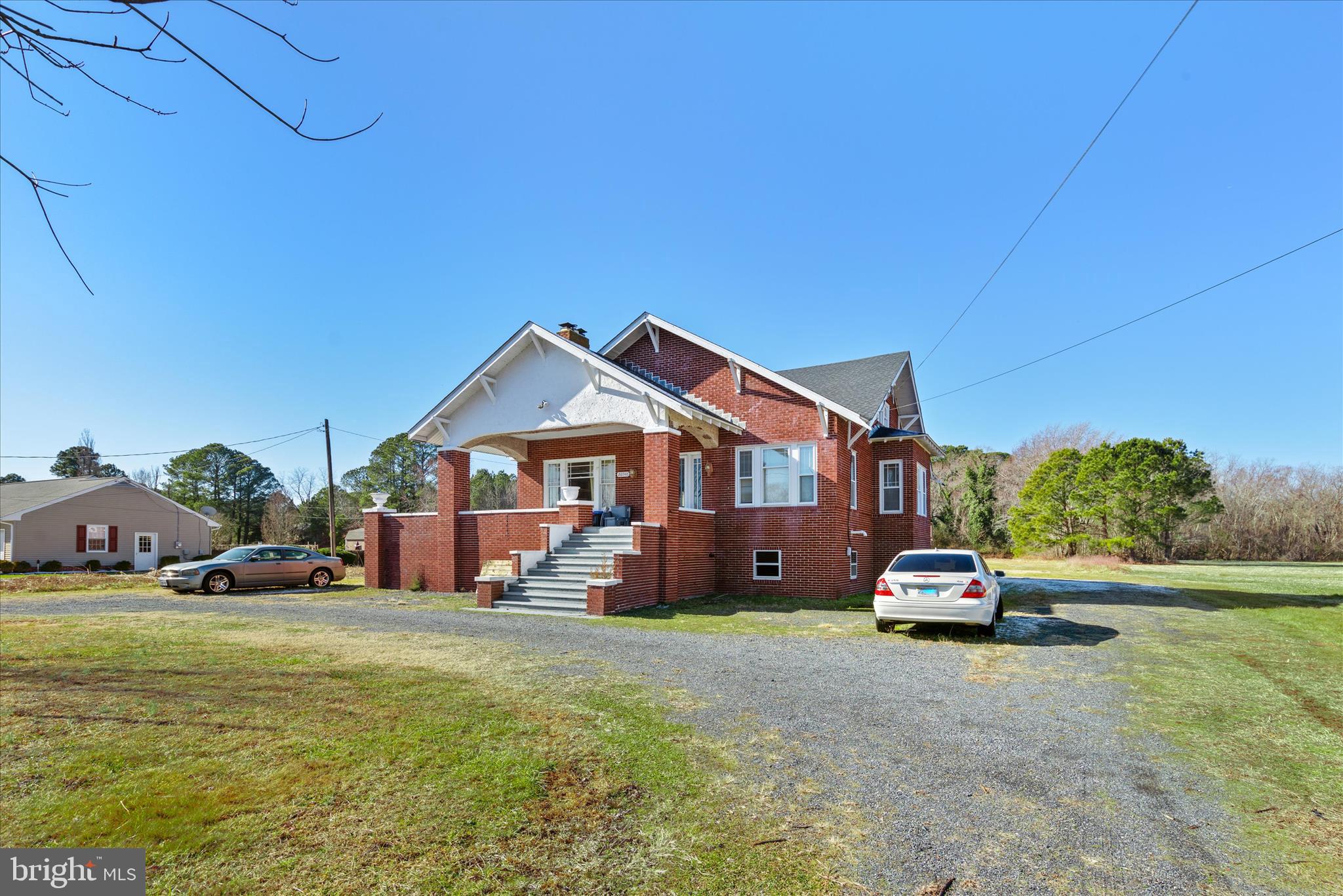 26740 Old State Road Crisfield, MD 21817 - Photo 2 of 49 a car parked in front of house with a yard
