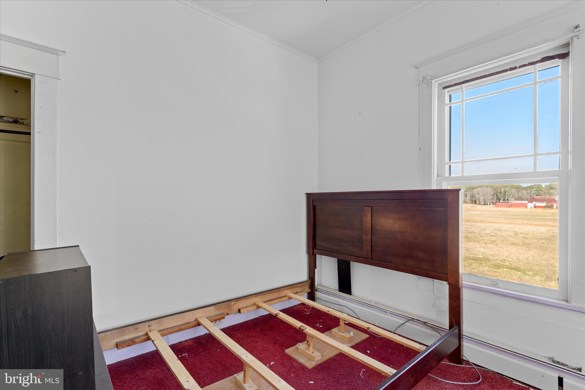 26740 Old State Road Crisfield, MD 21817 - Photo 25 of 49 a bench sitting in a bedroom next to a window