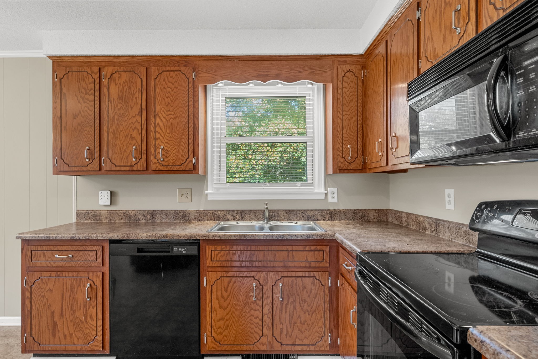 809 Pollard Road Clarksville, TN 37042 - Photo 11 of 28 a kitchen with stainless steel appliances granite countertop a stove a sink dishwasher and cabinets with wooden floor