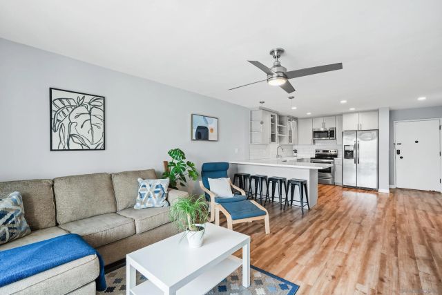 a living room with furniture and kitchen view