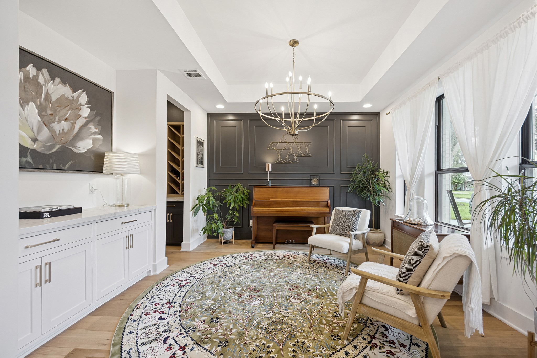 Formal dining room currently used as a piano and sitting area, featuring convenient built-in cabinets and drawers.
