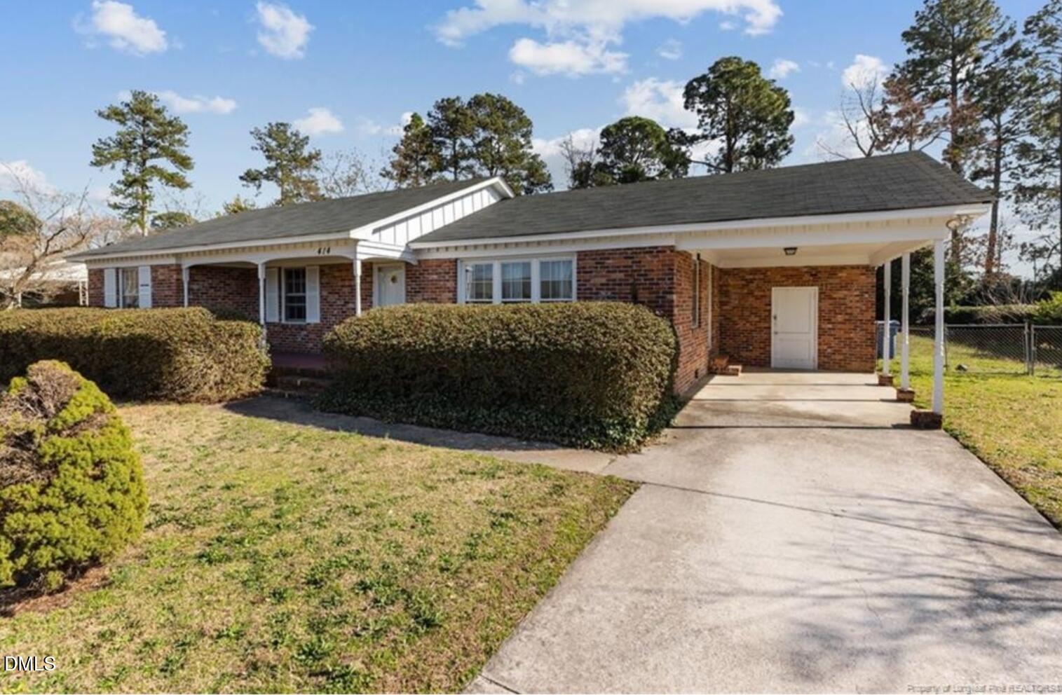 414 York Road Fayetteville, NC 28303 - Photo 2 of 14 a front view of a house with a yard and potted plants