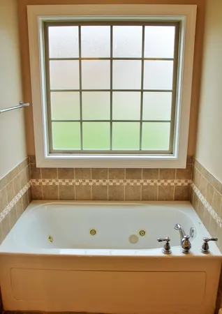 a bathroom with a bathtub and window