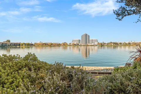 a view of a lake with houses in the back