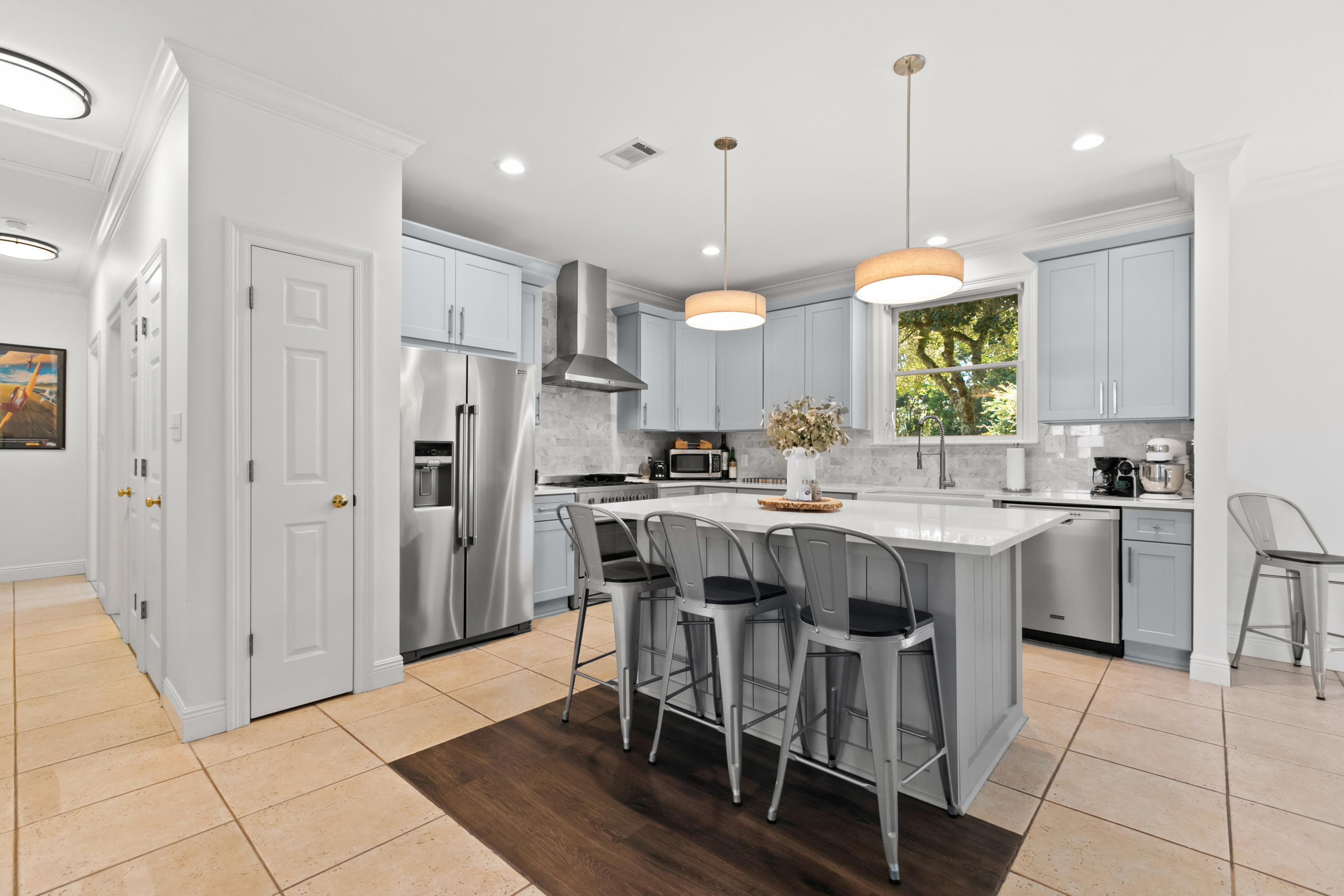 128 Beth Lane Santa Rosa Beach, FL 32459 - Photo 14 of 47 a kitchen with stainless steel appliances granite countertop a table chairs and a sink