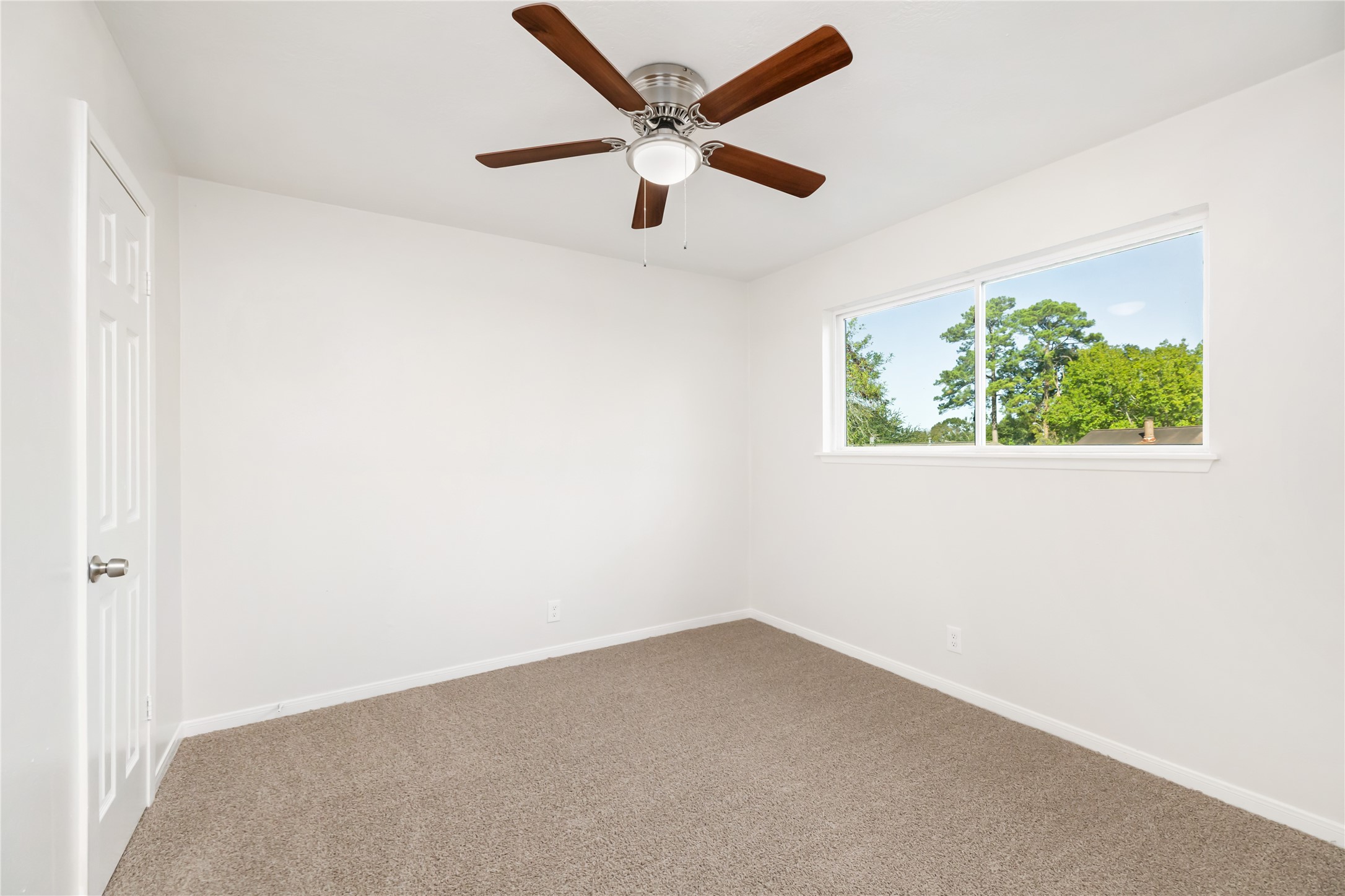 24118 Spring Mill Lane Spring, TX 77373 - Photo 20 of 24 an empty room with a window and a ceiling fan