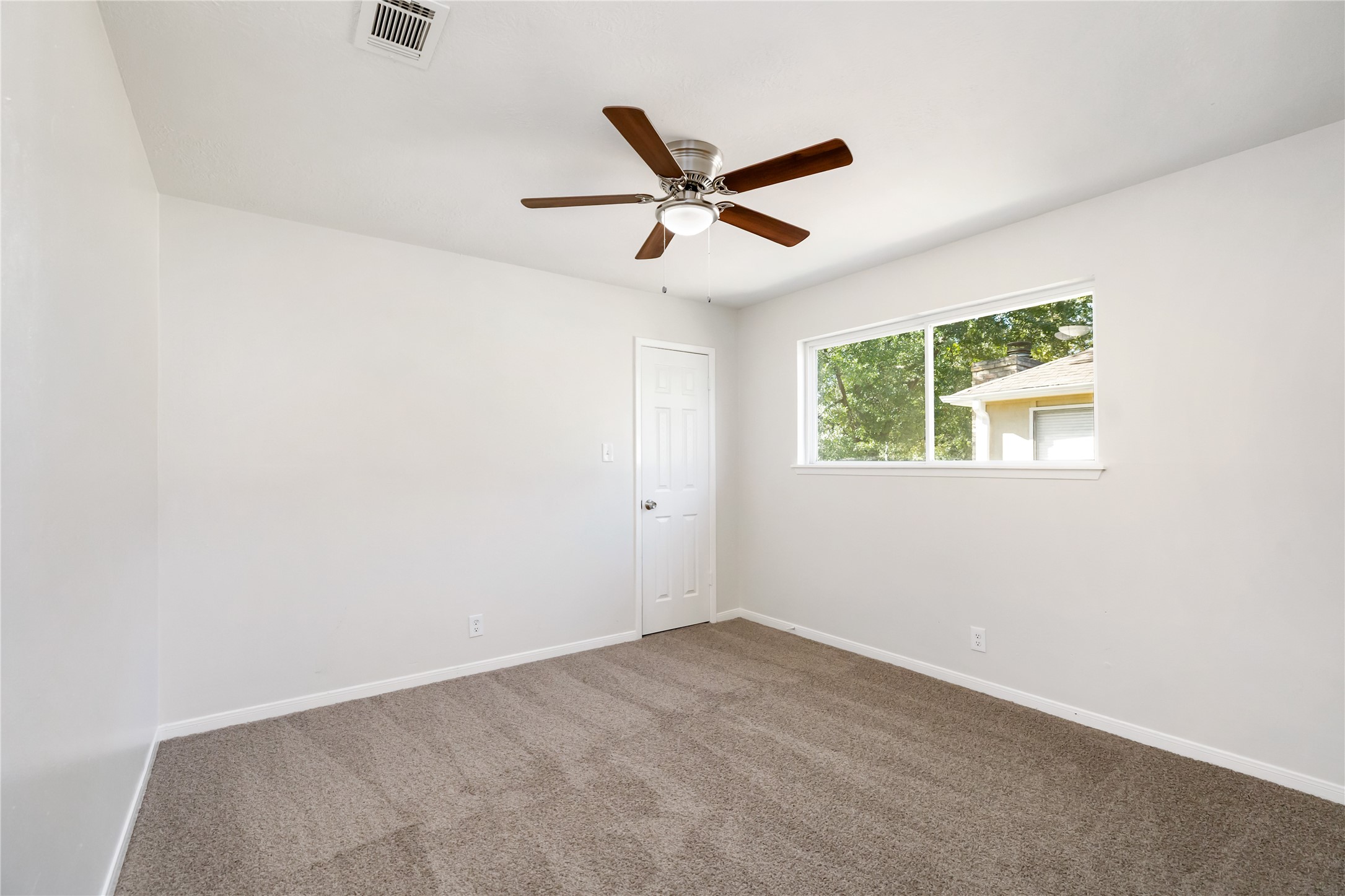 24118 Spring Mill Lane Spring, TX 77373 - Photo 23 of 24 an empty room with a window and a fan