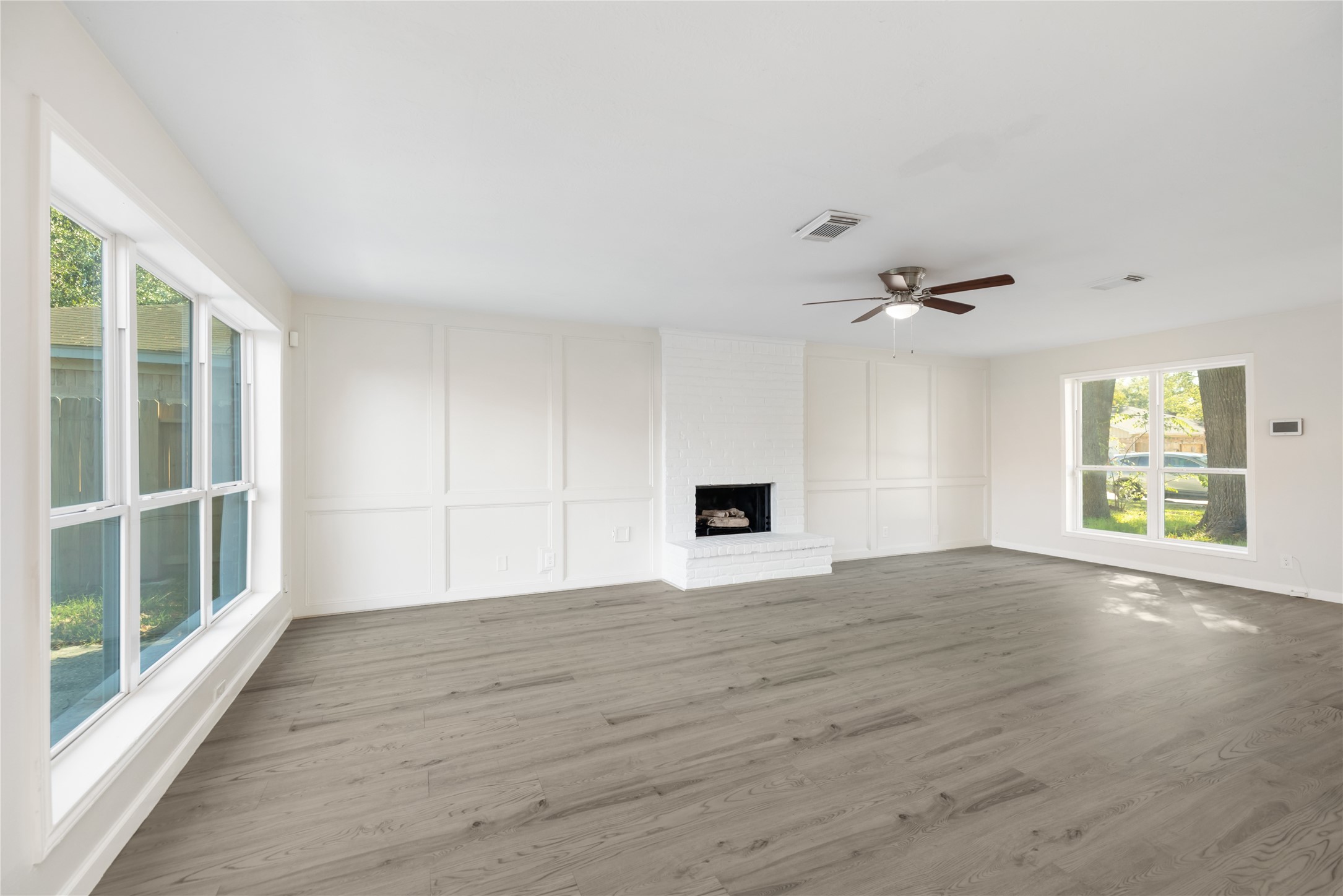 24118 Spring Mill Lane Spring, TX 77373 - Photo 7 of 24 a view of an empty room with wooden floor and a window