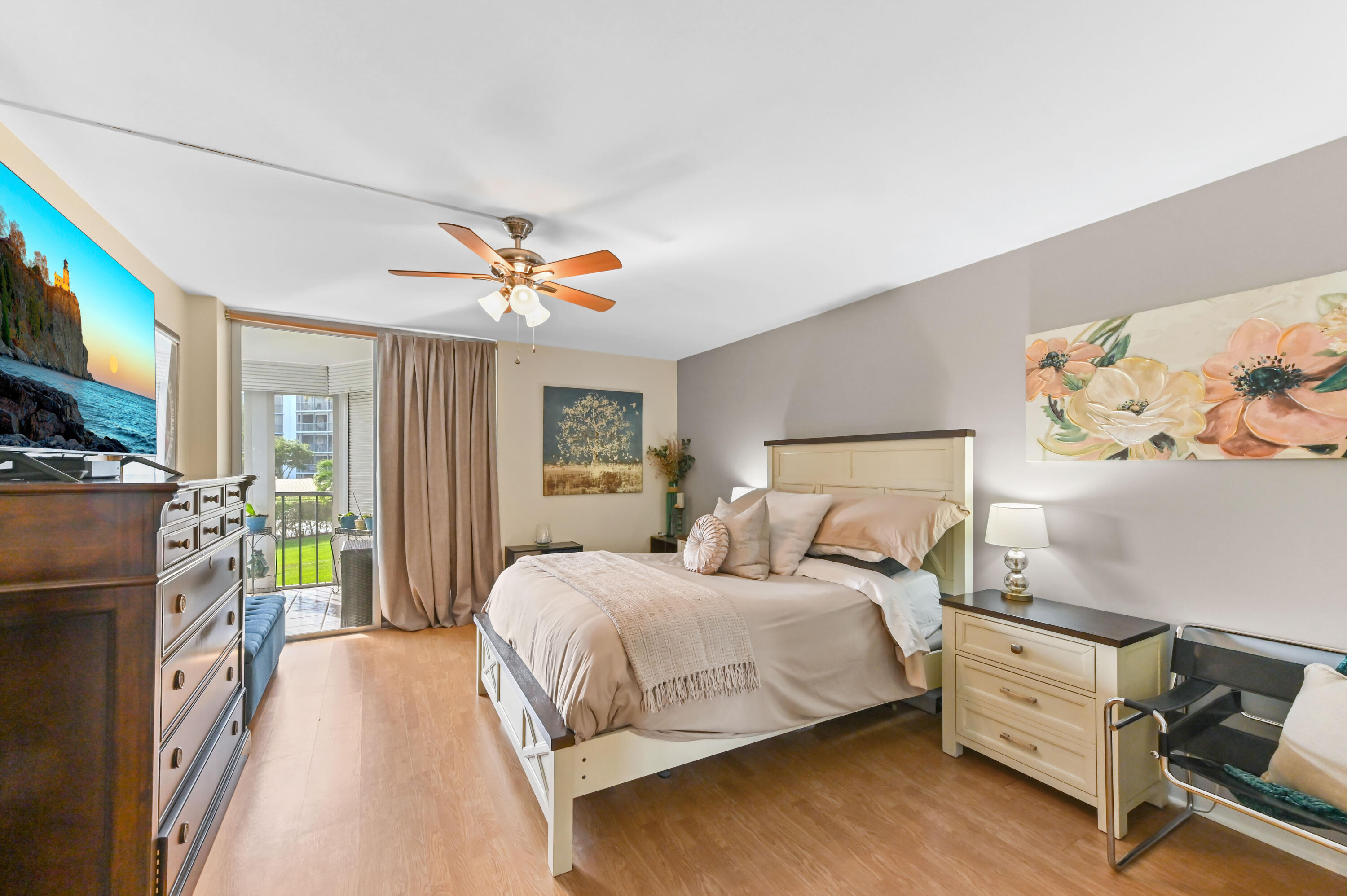 198 Northwest 67th Street, Unit 207 Boca Raton, FL 33487 - Photo 19 of 42 a bedroom with a bed and a chandelier