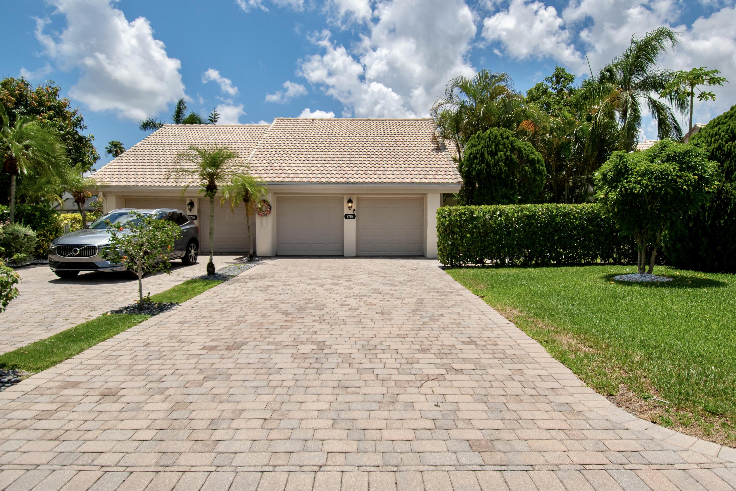 9708 Erica Court Boca Raton, FL 33496 - Photo 2 of 54 a front view of a house with a yard and a garage