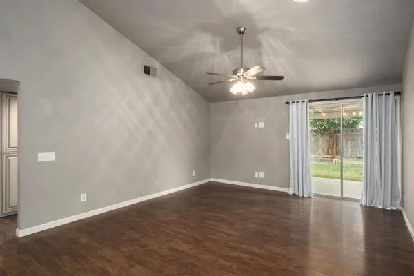 a living room with furniture a flat screen tv and a large window