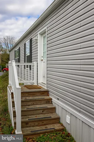 a view of a house with a door and a yard