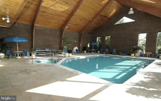 a view of a swimming pool with an outdoor seating