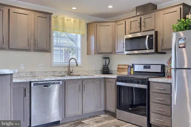 a kitchen with a sink stove and microwave