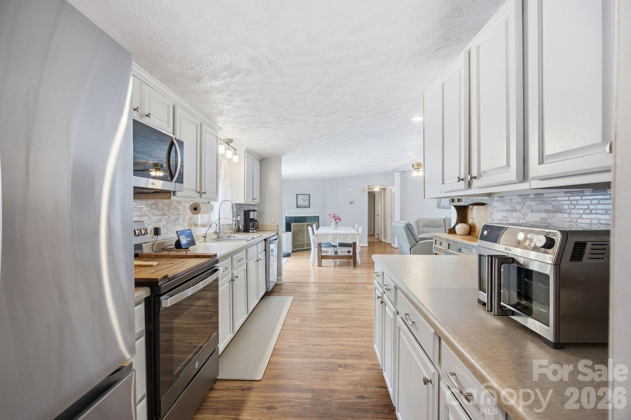 675 Overcash Road Salisbury, NC 28147 - Photo 22 of 48 a kitchen with stainless steel appliances granite countertop lots of counter top space and wooden floors