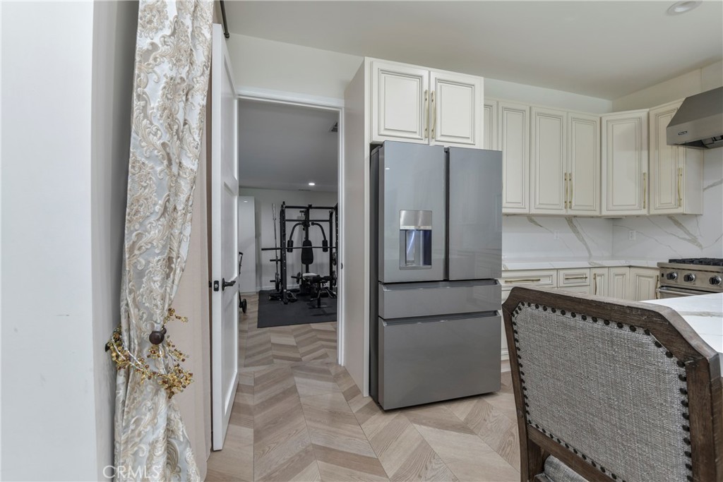 9728 Rhea Avenue Northridge, CA 91324 - Photo 16 of 36 a kitchen with granite countertop a refrigerator and a stove top oven