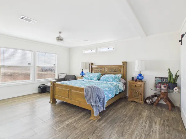 a bedroom with a bed and a large window with the outer view