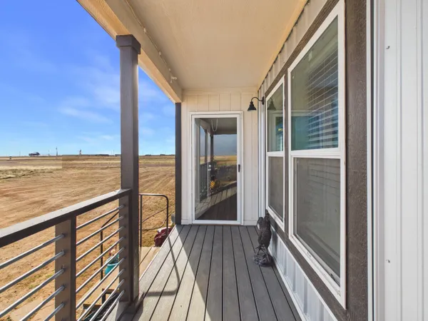 a view of a balcony with floor to ceiling window wooden floor with an outdoor view