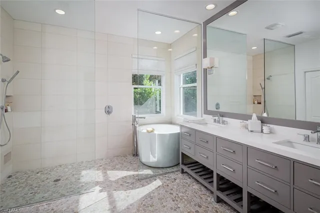 a bathroom with a double vanity sink toilet and shower