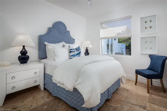 a spacious bedroom with a bed and window