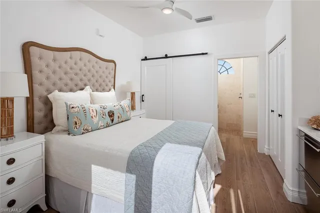 a bedroom with a bed and a mirror