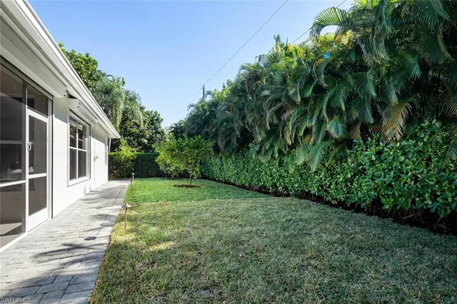 a view of a house with swimming pool and a yard