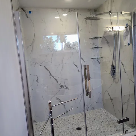 a bathroom with a glass shower door