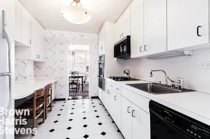 a kitchen with stainless steel appliances a sink stove top oven and cabinets