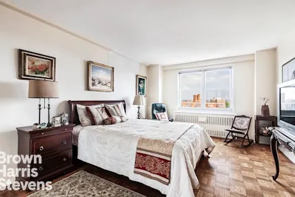 a bedroom with a bed a table and chair