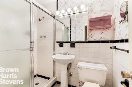 a bathroom with a sink mirror and toilet