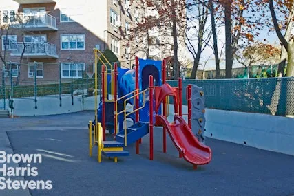 a view of a park with iron fence