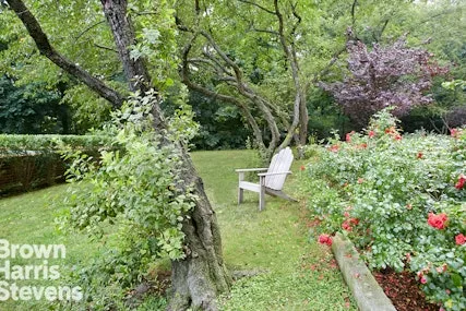a view of a chair and table in the garden