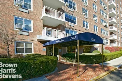 a view of a brick building next to a yard