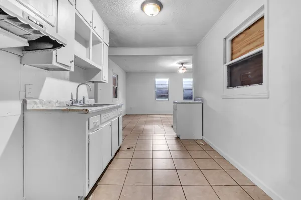 a kitchen with a sink and cabinets