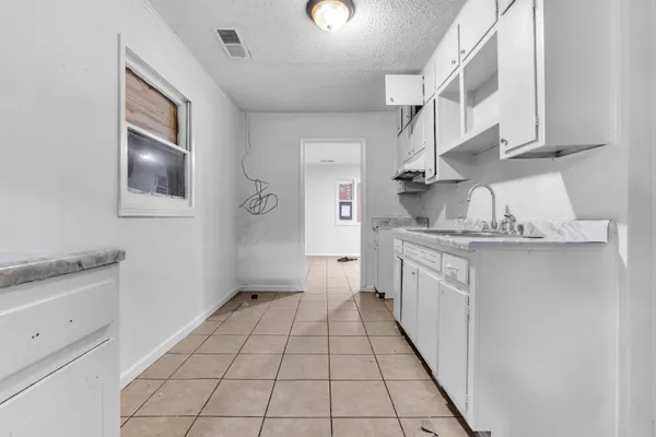 a kitchen with cabinets appliances and a counter space