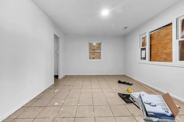 a white toilet sitting next to a white bath tub