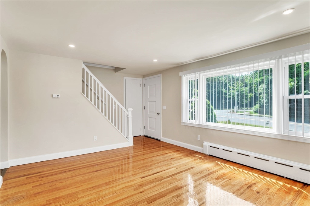 800 Wilbraham Road Springfield, MA 01109 - Photo 4 of 21 a view of an empty room with wooden floor and a window