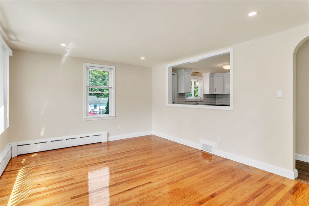 800 Wilbraham Road Springfield, MA 01109 - Photo 5 of 21 an empty room with wooden floor and windows
