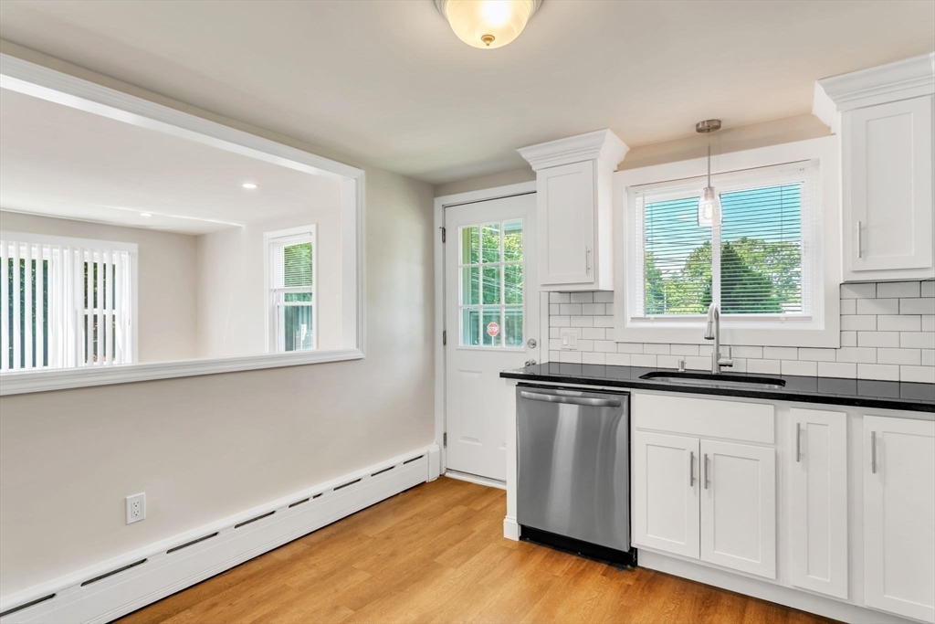 800 Wilbraham Road Springfield, MA 01109 - Photo 7 of 21 a kitchen with granite countertop white cabinets and a window