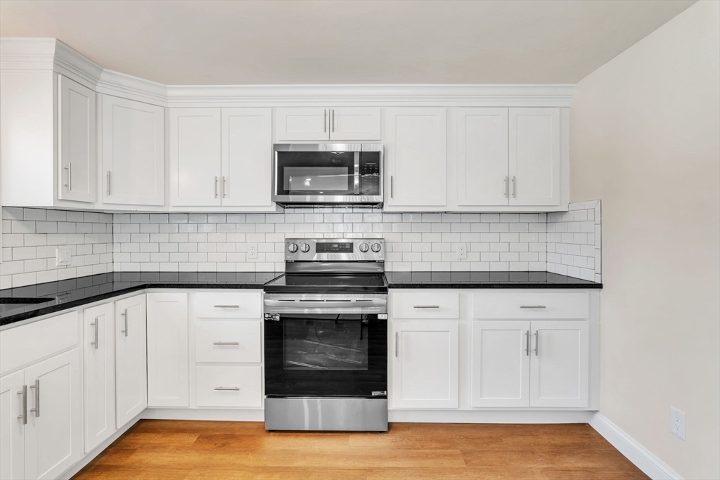 800 Wilbraham Road Springfield, MA 01109 - Photo 8 of 21 a kitchen with white cabinets and appliances