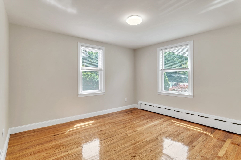 800 Wilbraham Road Springfield, MA 01109 - Photo 10 of 21 a view of an empty room with wooden floor and a window