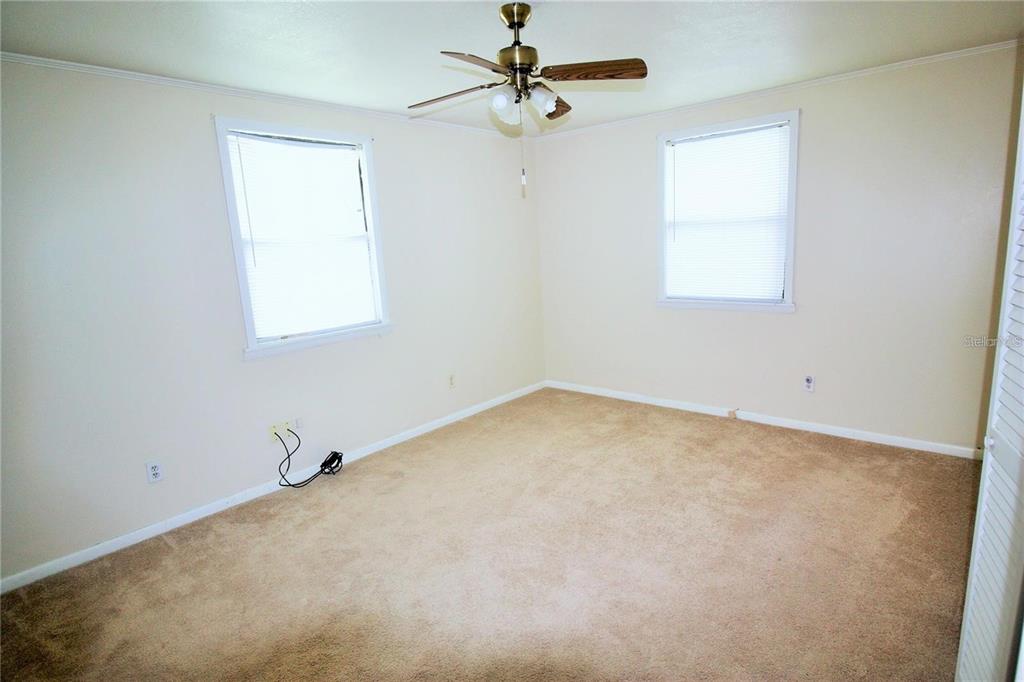 521 20th Street Southwest, Unit C Winter Haven, FL 33880 - Photo 11 of 18 an empty room with windows and fan