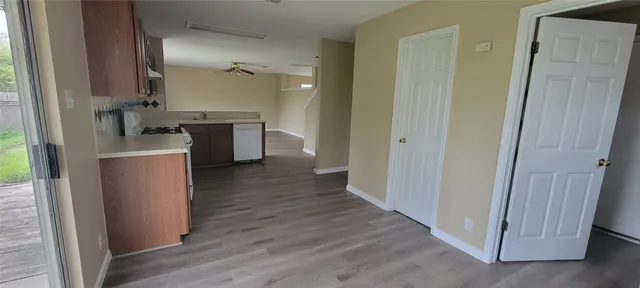 a kitchen with a refrigerator and a stove top oven